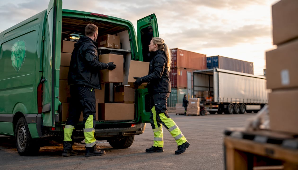 Delivery workers loading parcels into a cargo van