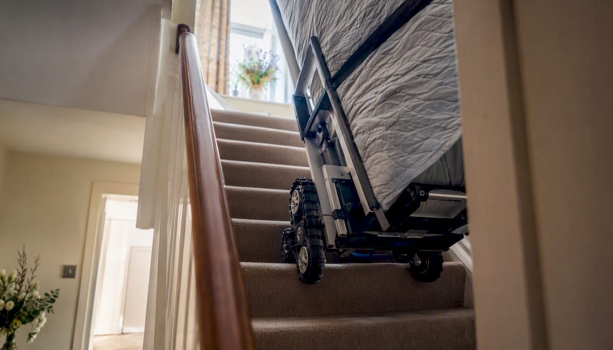 Stair-climbing trolley ascending narrow staircase