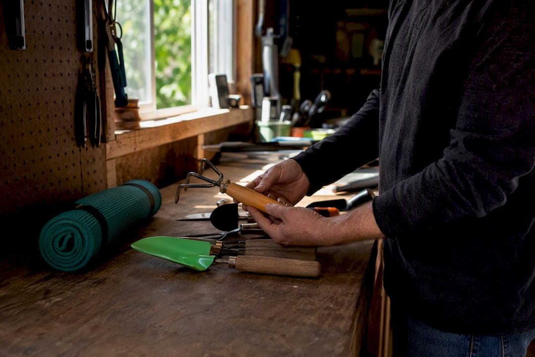 Hands organizing garage tools and equipment